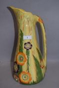 An early 20th century Carlton ware water jug having impressed and decorated floral design