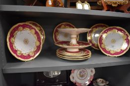 A set of late Victorian porcelain dinner plates having burgundy ground with gilt detailing.