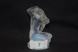 A modern art glass Lalique study of a nude female seated titled Floreal in opalescent glass signed