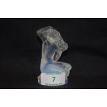 A modern art glass Lalique study of a nude female seated titled Floreal in opalescent glass signed