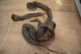 A lock of mouse brown human hair