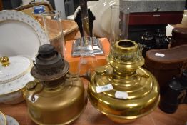 Two Victorian oil burning lamp bases both in brass