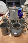 A selection of pewter wares including Tankards, twin handle vase and a very large water jug by The