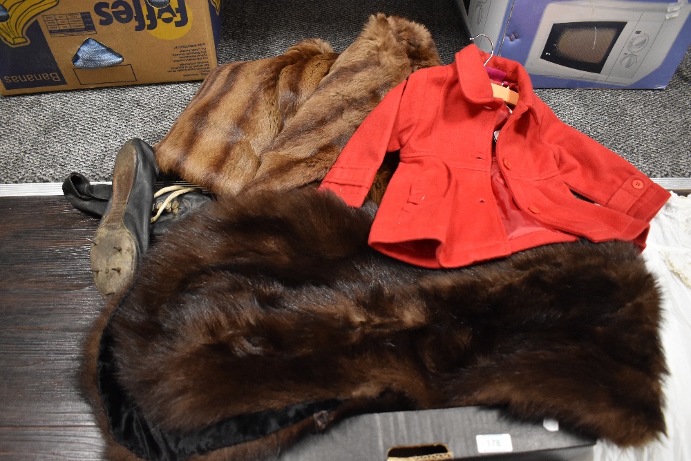 A selection of vintage textiles including childs red jacket, fur collars and night dress