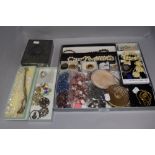 A selection of vintage and modern costume jewellery including necklaces, brooches, Yardley compact