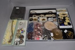 A selection of vintage and modern costume jewellery including necklaces, brooches, Yardley compact