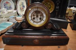 A Victorian drum head slate and red marble mantel clock by Henry Marc Paris, with visible escapement