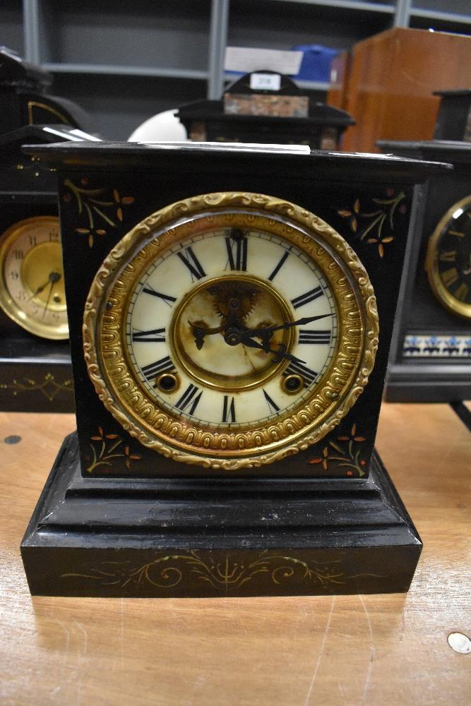 A Victorian cast iron mantel clock by the Ansonia American clock co,