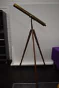 An antique floor standing brass bodied 3-inch refractor telescope with a terrestrial and