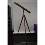 An antique floor standing brass bodied 3-inch refractor telescope with a terrestrial and