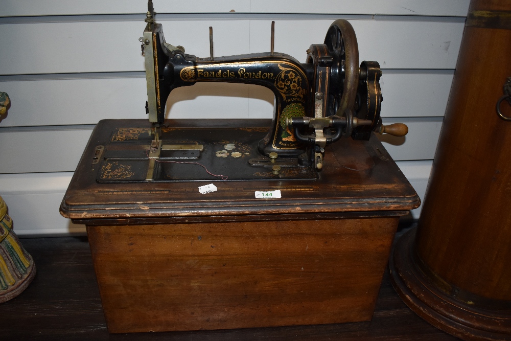 A Victorian Faudels London hand cranked sewing machine with fitted case