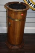 A Victorian stick or umbrella stand in coopered mahogany with brass banding and lions head handles