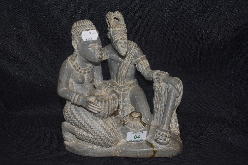 A mid century stone carved figure group possibly of two African Tribes. Base appears to be broken