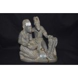 A mid century stone carved figure group possibly of two African Tribes. Base appears to be broken