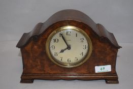 An early 20th century mantel clock having scroll work style case and 8 day movement