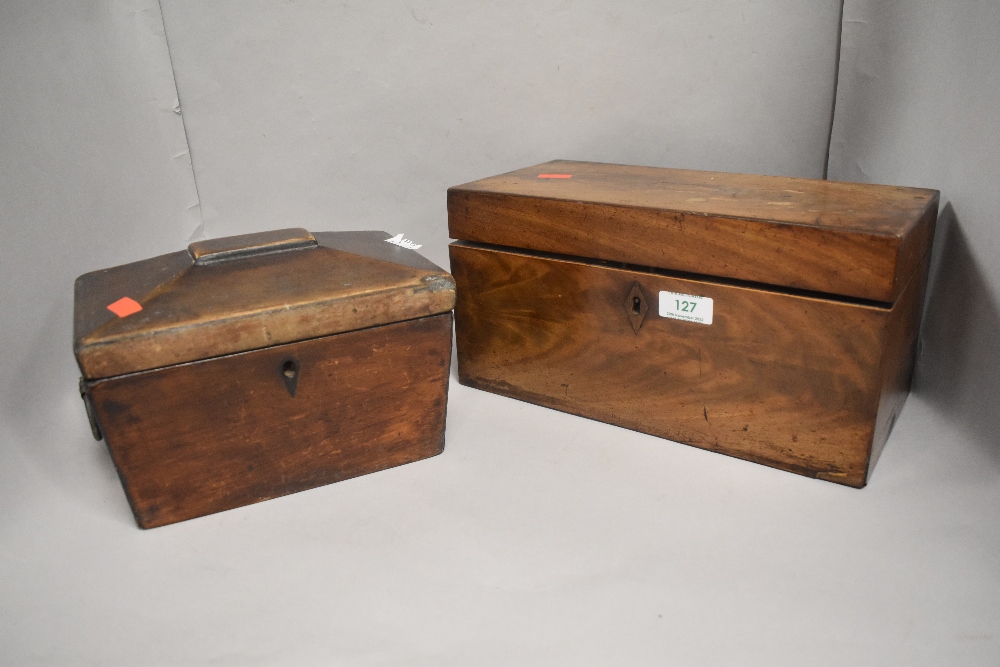 Two Victorian tea caddy, one in a casket form lacking interior, and larger mahogany cased example