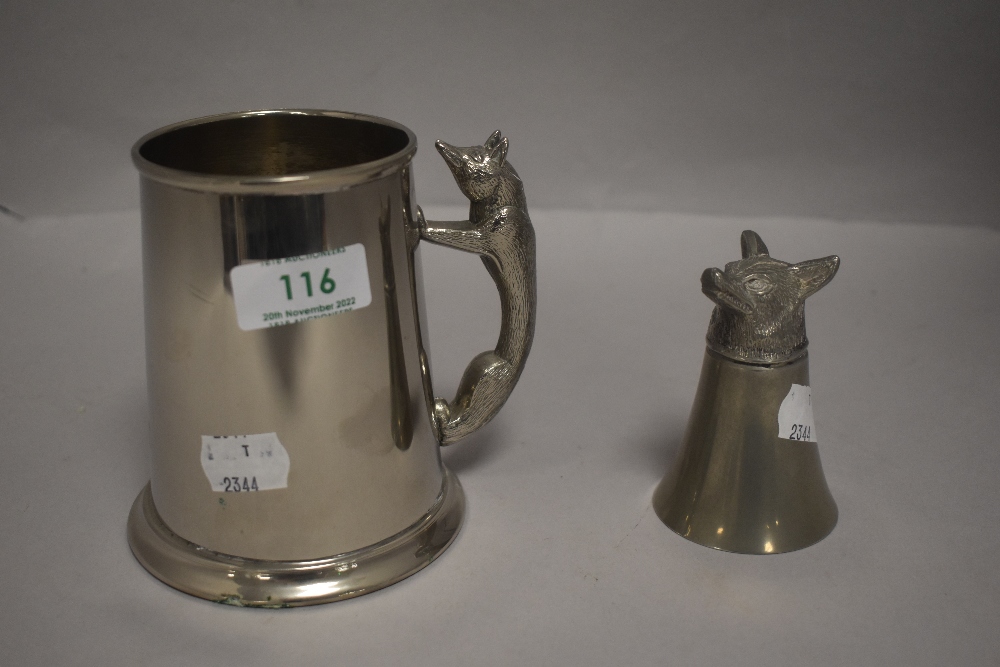 An early 20th century stirrup cup having a fox form base along with a fox handle tankard