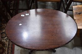 A reproduction occasional table, oval with four splay legs