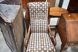 A 19th Century mahogany rocking chair having scroll frame, wih later upholstery