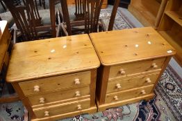 A pair of vintage pine three drawer bedside chests