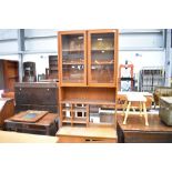 A vintage teak wall unit of narrow proportions with display and shelved section over double