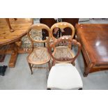 A pair of Victorian cane seated bedroom chairs and a stained frame baloon back chair