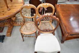 A pair of Victorian cane seated bedroom chairs and a stained frame baloon back chair