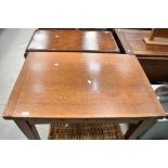 An early 20th Century oak drawer leaf dining table