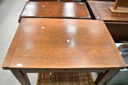 An early 20th Century oak drawer leaf dining table