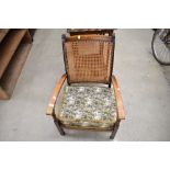 An early 20th Century stained frame bergere back armchair