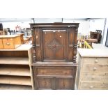 A modern oak court cupboard with drawer and cupboard storage