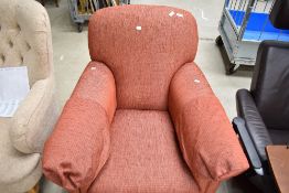 A modern easy chair in russet tones