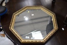 A gilt frame octagonal wall mirror