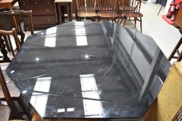 A vintage metal and glass designer dining table of octagonal form