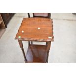 An early 20th Century oak occasional table having twist frame