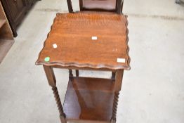 An early 20th Century oak occasional table having twist frame