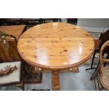 A modern pine circular dining table