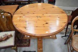 A modern pine circular dining table