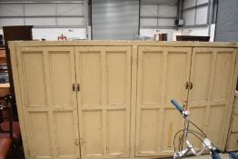 A Victorian pine painted larder unit with quadruple cupboard over 12 drawer base, overall height