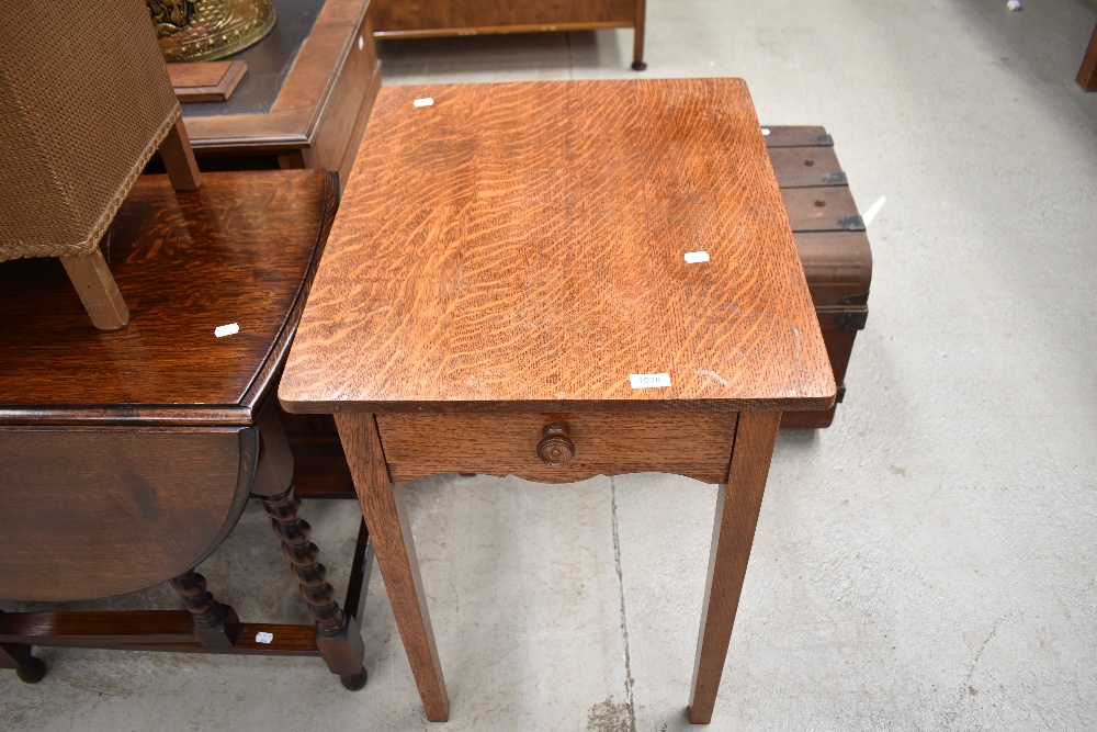 An early 20th Century oak occasional table with frieze drawer