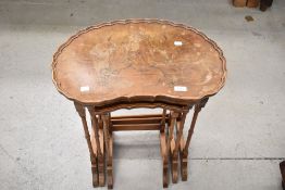 A reproduction walnut nest of three period style tables