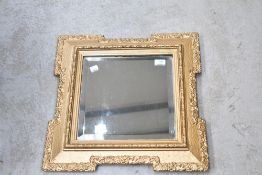 A 19th Century wall mirror having shaped gilt frame