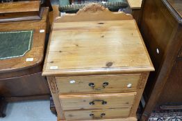 A pine chest of three low drawers