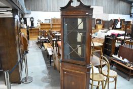 An Edwardian mahogany corner display with cupboard under