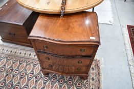 A reproduction Regency mahogany serpentine front bedside chest