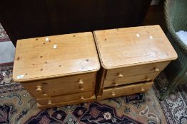 A pair of vintage pine three drawer bedside chests