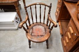 A 19th Century spindle back armchair having turned frame and twine seat