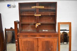 A Victorian substantial library book case and cupboard in mahogany with drawer and under cupboard
