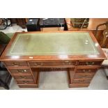 A reproduction yew wood pedestal desk