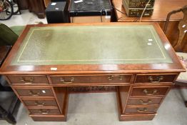 A reproduction yew wood pedestal desk